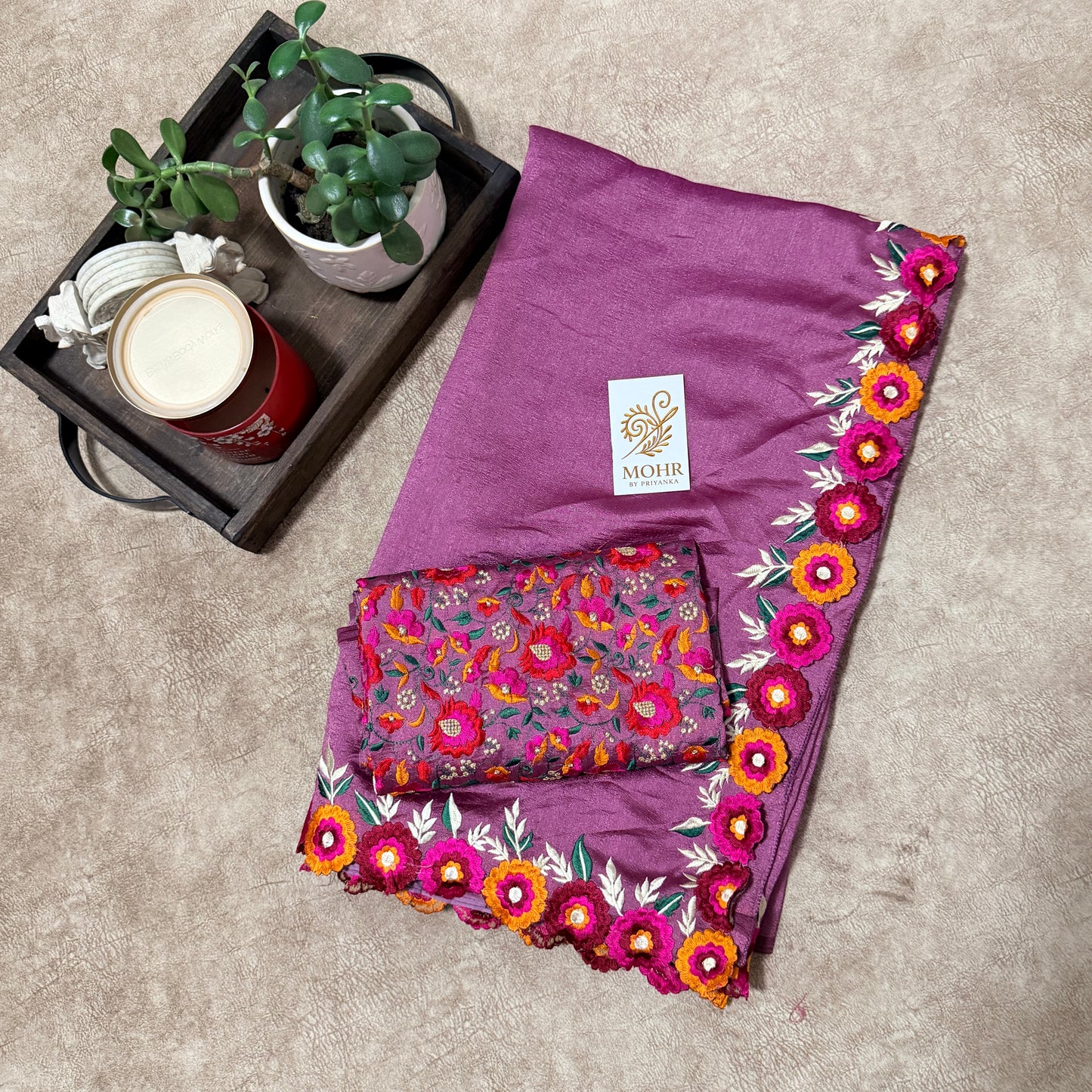 Mauve silk saree with flower border.